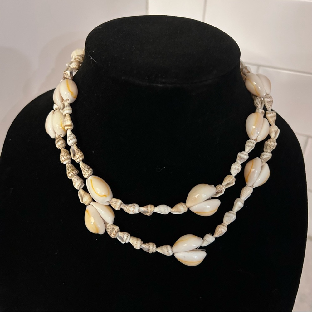 Lot of 3 Vintage Cowrie and Conch Shell Jewelry. Two necklaces and a bracelet.
